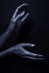 beautiful man's hands in silver paint