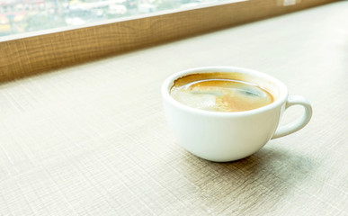 Espresso Coffee cup on wood table in cafe with blur background,