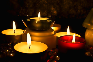 group of candles against a dark background