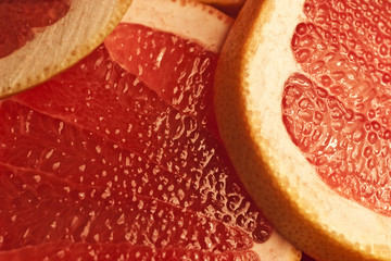 Parts of a  red grapefruit close up
