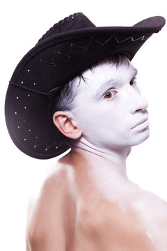 man in black cowboy hat and white makeup
