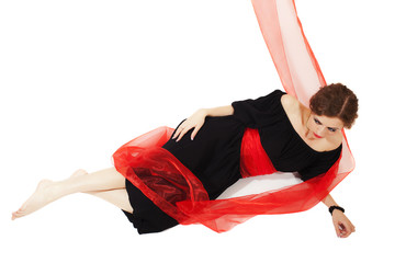 woman in black dress with red sash on white background