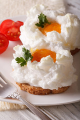 Beautiful food: fried eggs Orsini and tomatoes close-up. vertical
