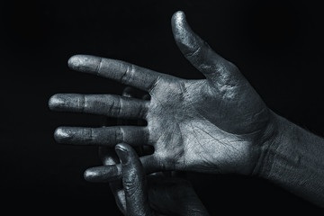 Men's hand in a silver paint