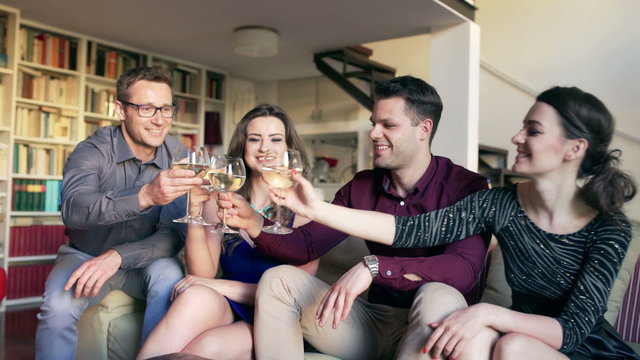 Friends drinking wine and smiling to the camera, steadycam shot
