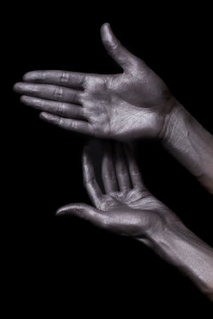 beautiful men hands with long fingers in silver paint