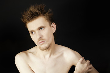 Fototapeta premium young serious man with blue eyes and a stylish hairstyle