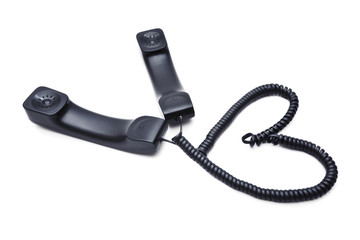 Two handsets with wires woven into a heart-shaped