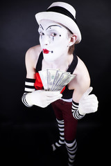 funny mime in white hat and gloves, holding a stack of hundred-d
