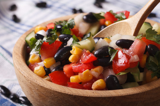Mexican salad with black beans, avocado, corn and tomatoes macro 

