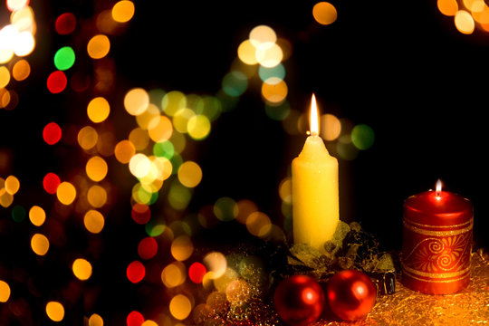 Burning candle with Christmas-tree decoration