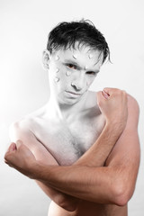 young man with white makeup and hearts on face