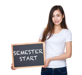 Young lady hold with blackboard showing semester start