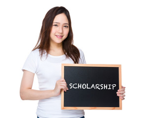 Young woman hold with blackboard showing a word scholarship