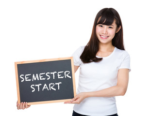 Fototapeta premium Woman hold with chalkboard showing semester start