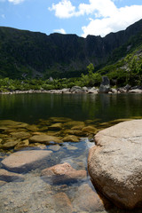 Stones in lake in mountains.