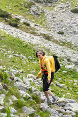 Naklejka na ściany i meble Woman hiking into the mountains