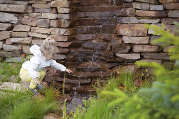 The child in front of a small waterfall