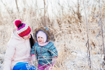 Happy family playing in winter outdoors