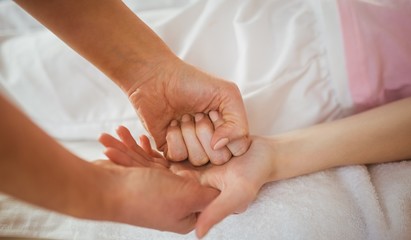 Fototapeta na wymiar Young woman getting hand massage