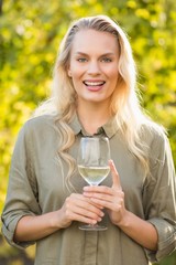 Young happy woman holding a glass of wine