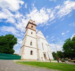 Fototapeta na wymiar Evanghelic Church in Bistrita city in Transylvania Region of Romania built with gothic and renaissance elements on a sunny summer day with a beautiful blue cloudy sky