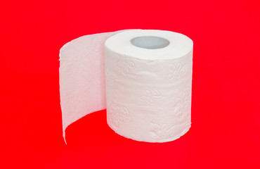 Toilet paper roll on red dangerous alerted important background suggesting diarrhea digestive and toilet problems and issues with a serious look