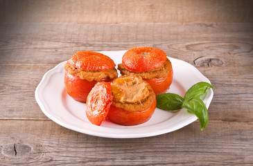 Stuffed tomatoes on a white plate. 