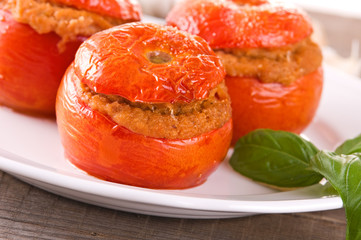 Stuffed tomatoes on a white plate. 