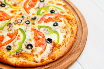 pizza on wooden plate
