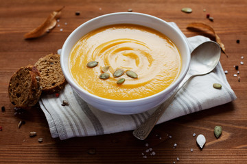 Pumpkin soup in white bowl, dietary vegetable soup