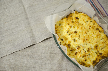 Homemade cheesecake in glass baking dish. Cottage cheese pie top view.