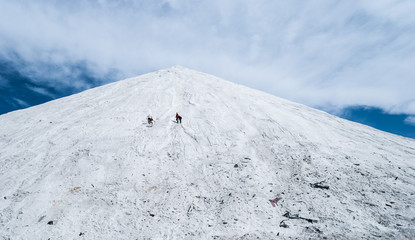 White Mountain relief against the blue sky with white clouds volume