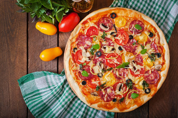 Pizza with salami, tomato, cheese and olives