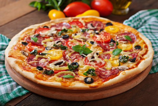 Pizza with salami, tomato, cheese and olives