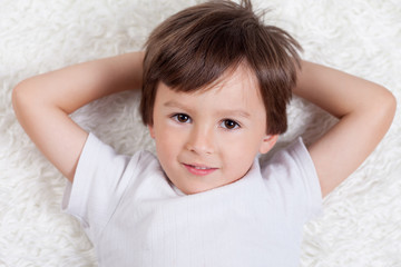 Adorable sweet happy toddler boy looking at camera