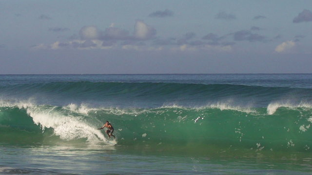 Surfer Jumps Off His Board in the Barrel. Big Shorebreak Surf in Hawaii in Super Slow Motion
