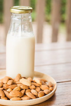 Bottle of almond milk on wooden table