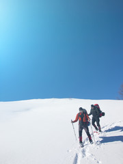 Fototapeta na wymiar Men go snowshoeing in the mountains in the snow.