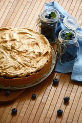 Homemade cake with blueberries on wooden background