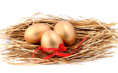 Three golden eggs in the nest isolated on white background