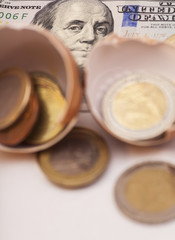 Broken egg with coins