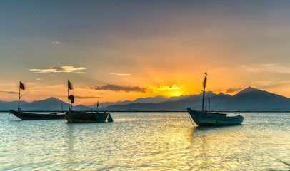 Sunset light Danang with dark sky bright rays make permissive lively mountain dawn, the quiet thuyem also preparing to go to sleep