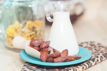 Almonds caramel with milk on table. Selective focus, shallow DOF