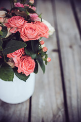 Bouquet of roses in vintage coffee pot