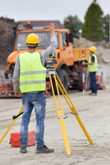 Workers with theodolite