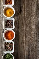 Obraz na płótnie Canvas spices in bowls in horizontal row