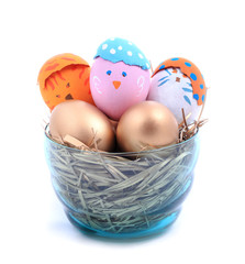 Color paint easter eggs in the nest on white background.