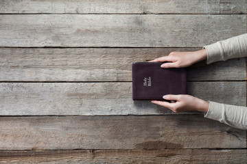 christian woman holding the bible. top angle of view