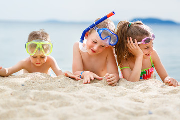 Children having fun on the beach after scuba diving